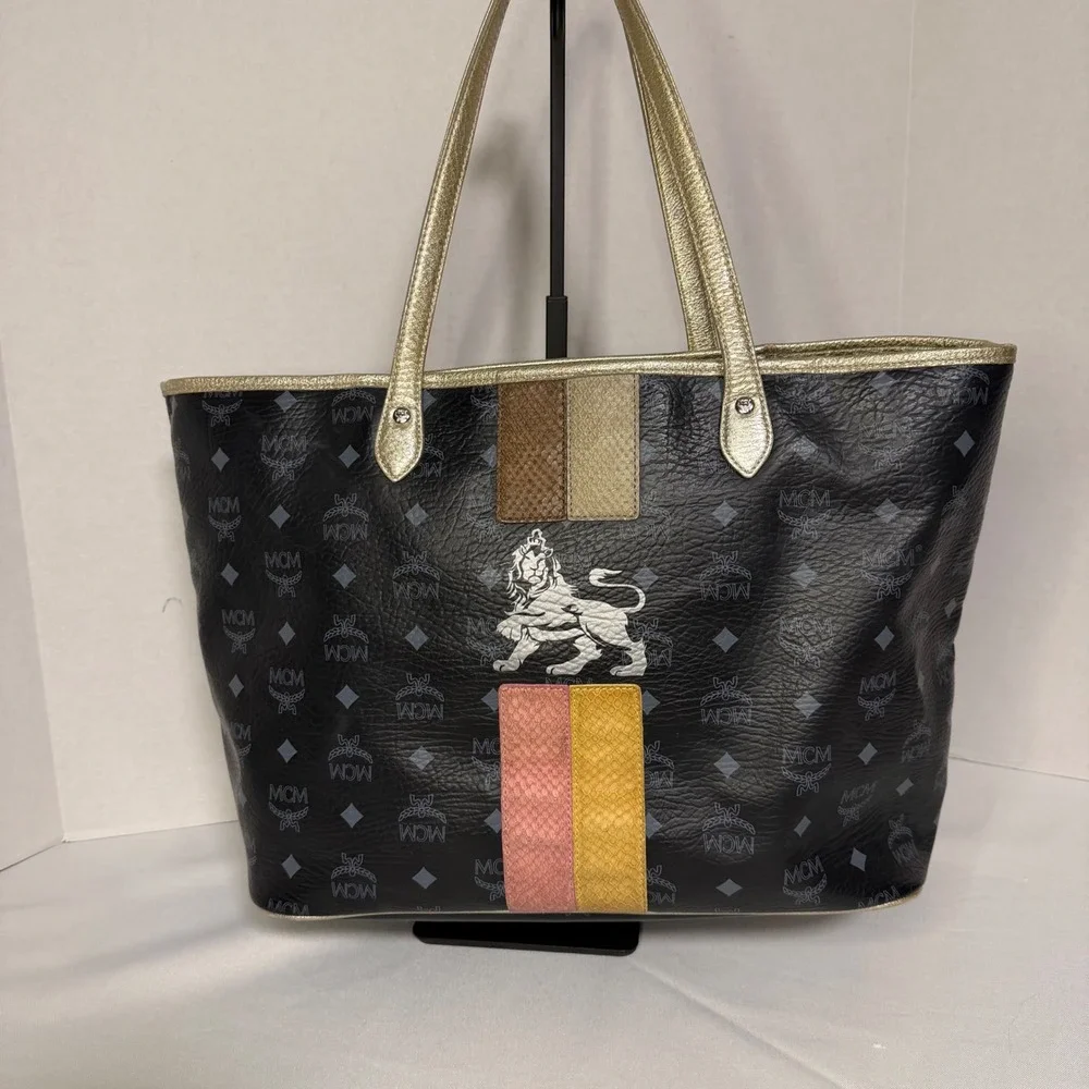 MCM Visetos Monogram Medium Tote Bag Black Gold‎ Lion Graphic Striped